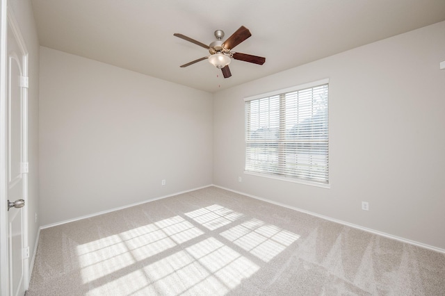 spare room with light carpet and ceiling fan