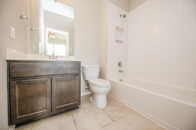 full bathroom featuring toilet, vanity, tiled shower / bath, and tile patterned flooring