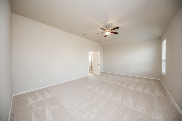 carpeted empty room featuring ceiling fan and lofted ceiling