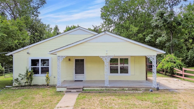 bungalow-style home featuring a front yard and a porch