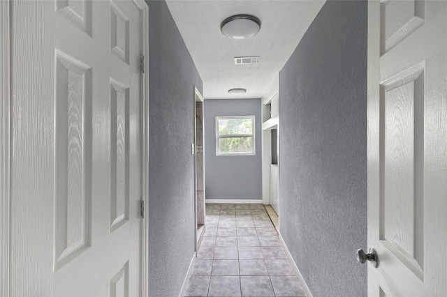 corridor with light tile patterned floors