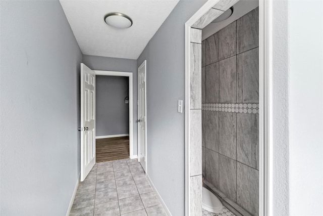 corridor featuring light tile patterned flooring