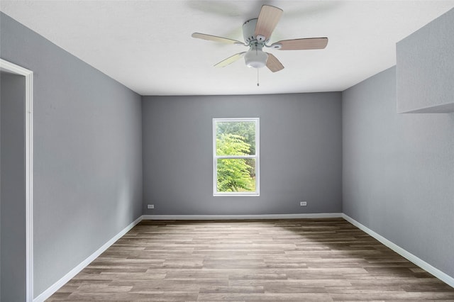 unfurnished room with ceiling fan and light wood-type flooring