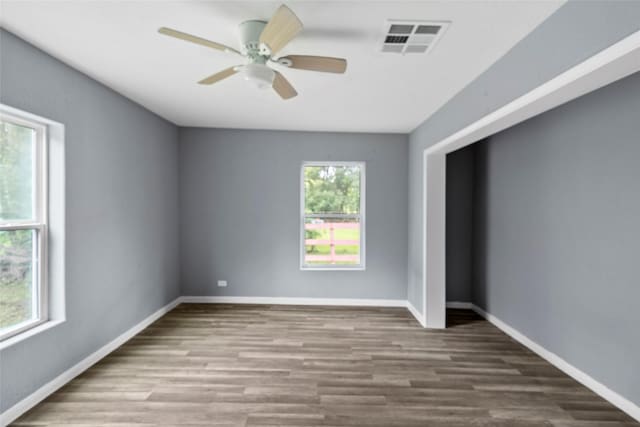 spare room featuring hardwood / wood-style floors and ceiling fan