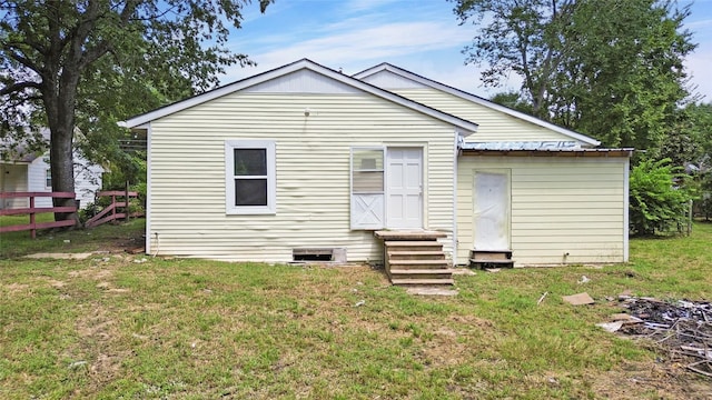 back of house with a yard