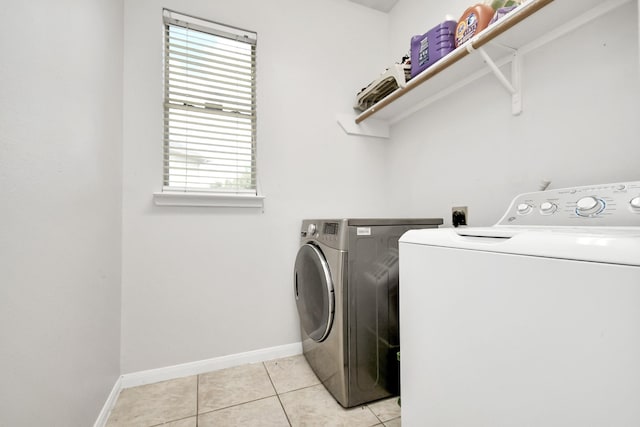 laundry room featuring plenty of natural light, light tile patterned floors, and independent washer and dryer