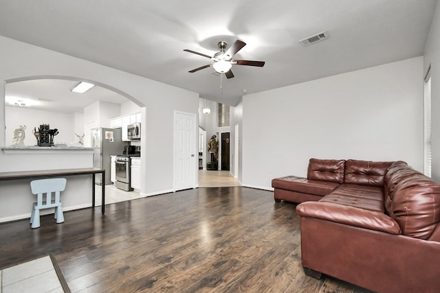 living room with ceiling fan and dark hardwood / wood-style flooring