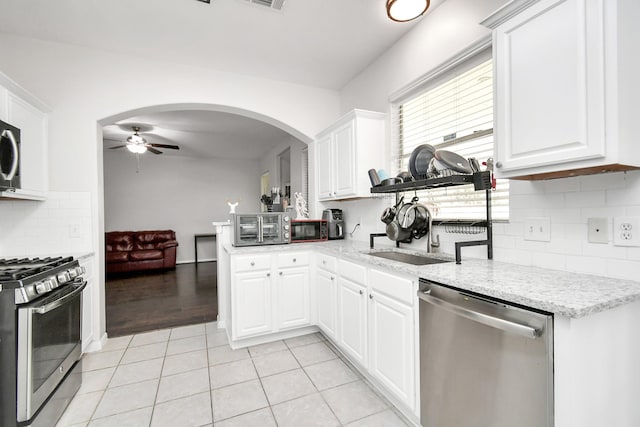 kitchen with white cabinetry, light tile patterned floors, and stainless steel appliances