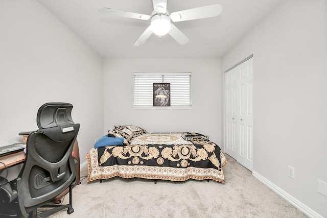 carpeted bedroom with a closet and ceiling fan