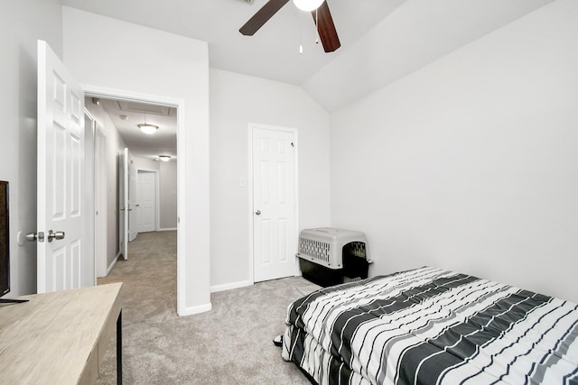 carpeted bedroom with ceiling fan and vaulted ceiling