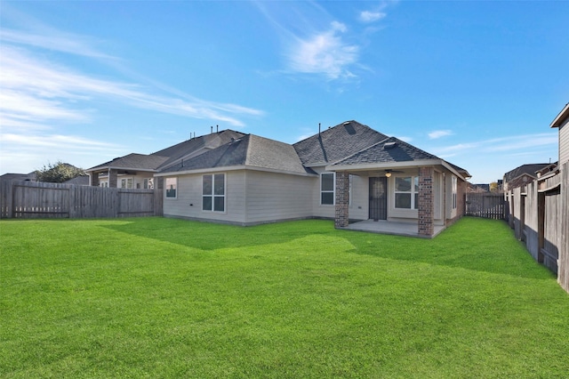 back of house with a patio area and a lawn