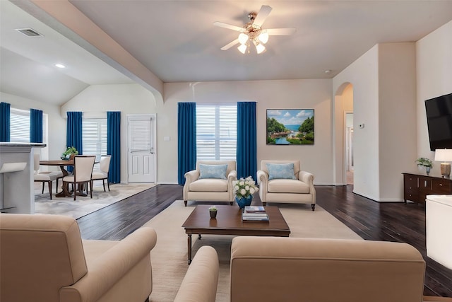 living room with hardwood / wood-style flooring, ceiling fan, and vaulted ceiling