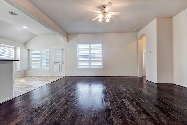 unfurnished living room with vaulted ceiling, a healthy amount of sunlight, dark hardwood / wood-style floors, and ceiling fan