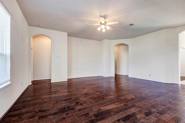 empty room with ceiling fan and dark wood-type flooring