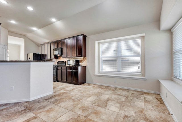 kitchen featuring backsplash, black appliances, vaulted ceiling, and dark brown cabinetry