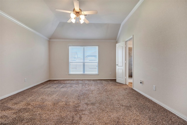 spare room featuring crown molding, carpet floors, vaulted ceiling, and ceiling fan