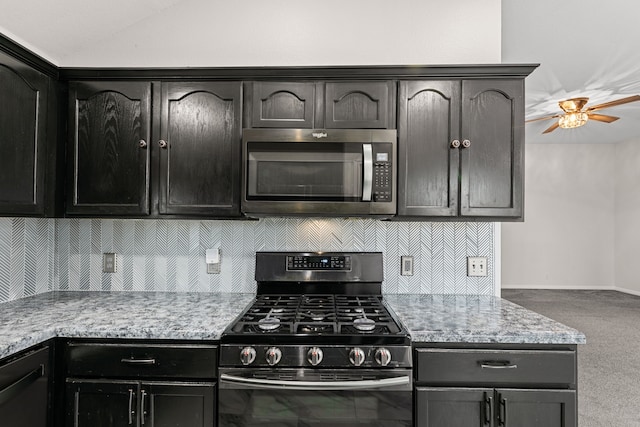 167 Hay Meadow Rd, Cedar Creek, TX 78612 - kitchen featuring stainless steel appliances, ceiling fan, carpet floors, tasteful backsplash, and dark cabinets