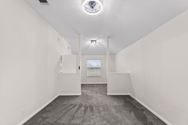 carpeted spare room with lofted ceiling