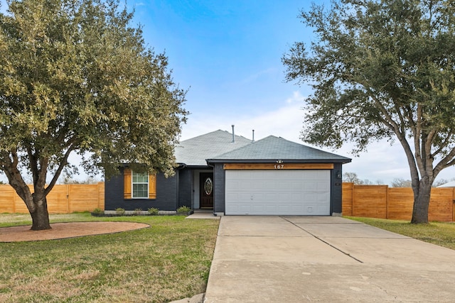 view of front of home with a garage and a front lawn