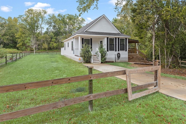 farmhouse with covered porch and a front lawn