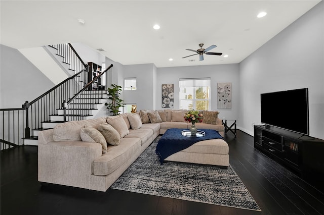 living room with dark wood-type flooring and ceiling fan