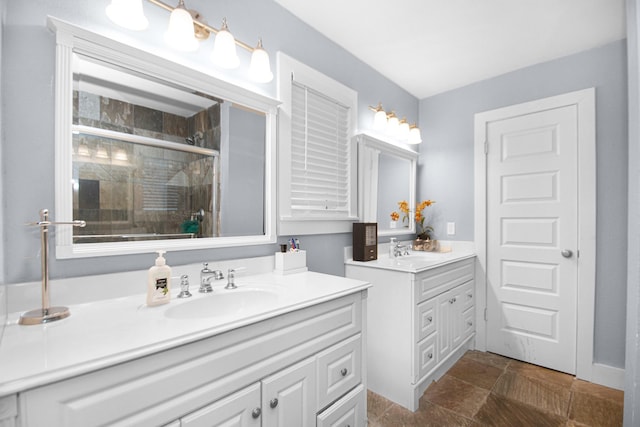 bathroom featuring walk in shower and vanity