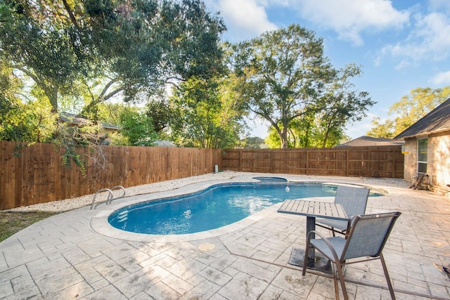 view of swimming pool featuring an in ground hot tub and a patio area