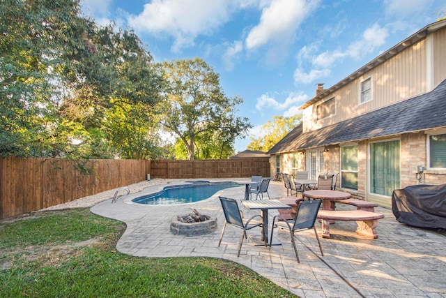 view of pool with an outdoor fire pit and a patio