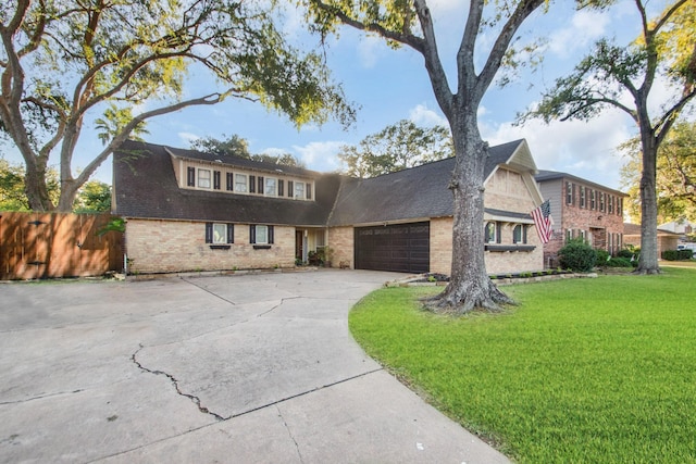 view of front of property with a garage and a front lawn