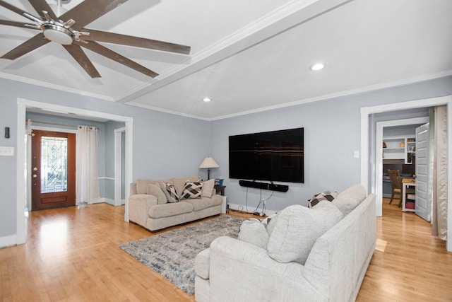 living room featuring light hardwood / wood-style flooring, beamed ceiling, ceiling fan, and ornamental molding