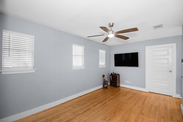 unfurnished living room featuring ceiling fan and light hardwood / wood-style floors