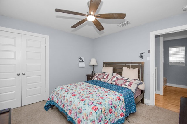 carpeted bedroom with a closet and ceiling fan