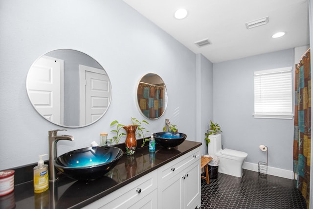 bathroom featuring toilet and vanity