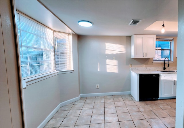 kitchen featuring sink, white cabinets, dishwasher, and light tile patterned flooring