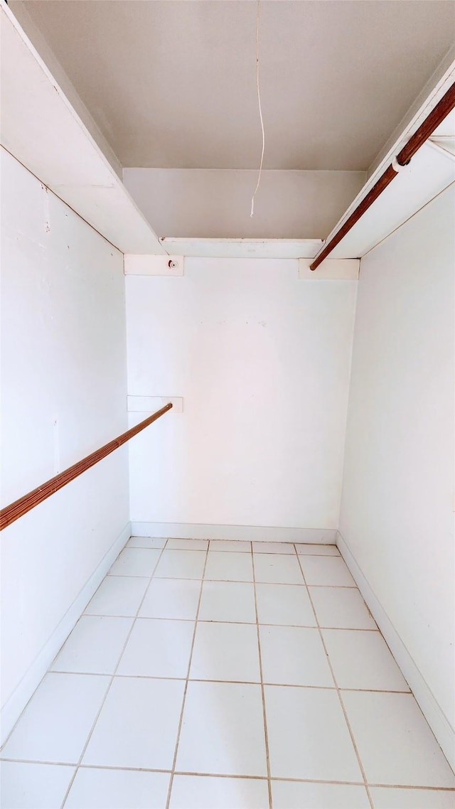 spacious closet with light tile patterned floors