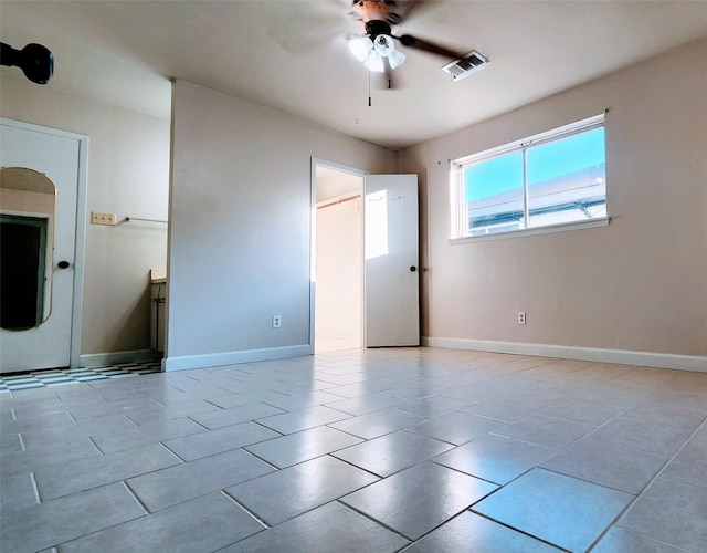 unfurnished bedroom featuring light tile patterned flooring and ceiling fan