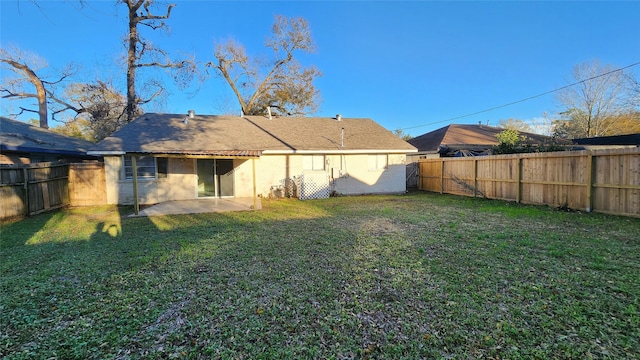 rear view of property with a patio and a yard