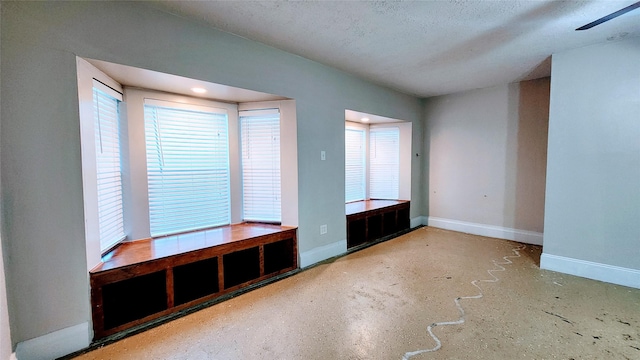 unfurnished room featuring a textured ceiling