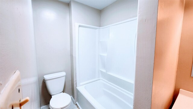 bathroom featuring bathing tub / shower combination and toilet