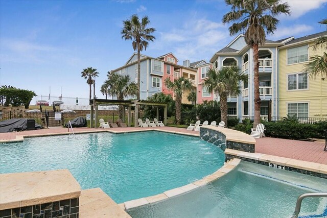 view of pool featuring a patio area, pool water feature, and a pergola