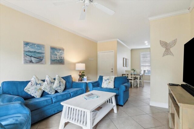 living room with ceiling fan, ornamental molding, and light tile patterned flooring