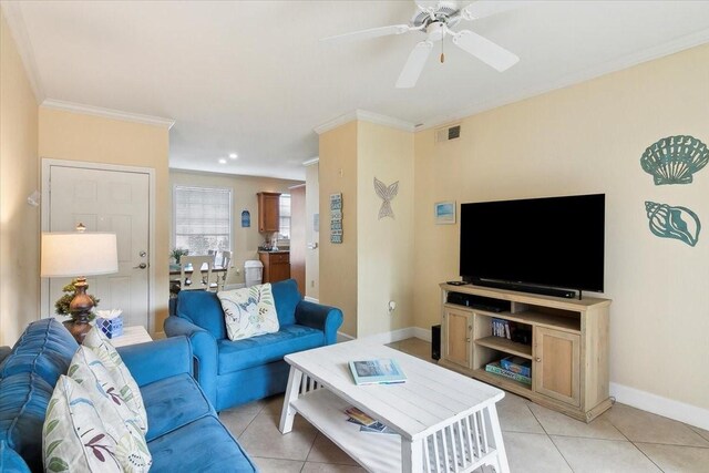 living room featuring ceiling fan, ornamental molding, and light tile patterned floors