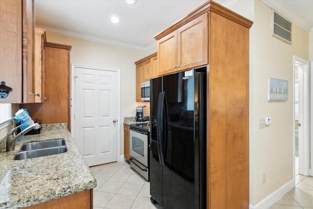 kitchen featuring sink, ornamental molding, light tile patterned floors, and stainless steel appliances