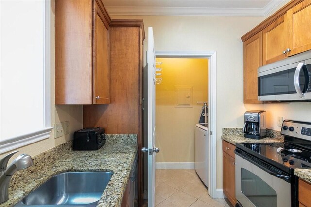 kitchen with appliances with stainless steel finishes, sink, ornamental molding, light tile patterned flooring, and light stone counters