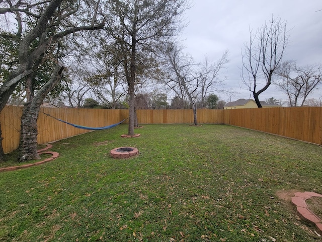 view of yard with a fire pit