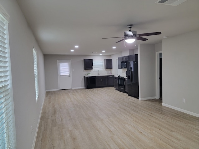 kitchen with sink, black appliances, ceiling fan, and light hardwood / wood-style floors