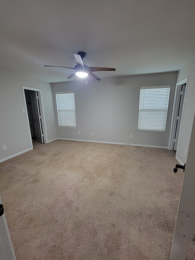 carpeted empty room with ceiling fan