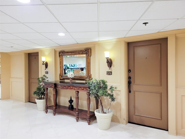 interior space with a paneled ceiling