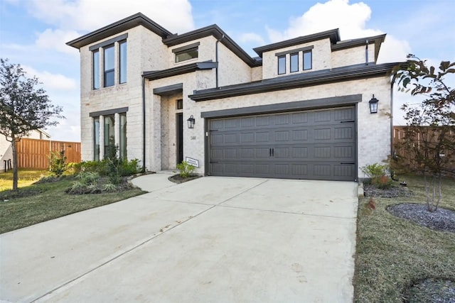 view of front of home with a garage and a front lawn