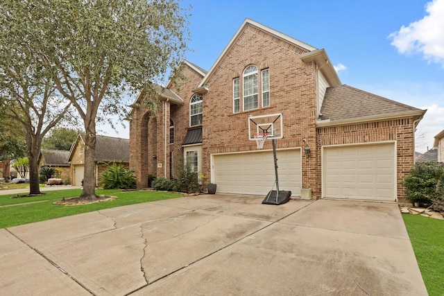 front facade with a garage and a front lawn